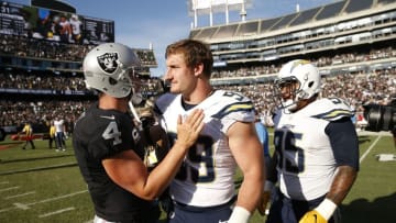 Oct 9, 2016; Oakland, CA, USA; Oakland Raiders quarterback Derek Carr (4) meets with San Diego Chargers defensive end Joey Bosa (99) after the game at Oakland Coliseum. The Raiders defeated the Chargers 34-31. Mandatory Credit: Cary Edmondson-USA TODAY Sports