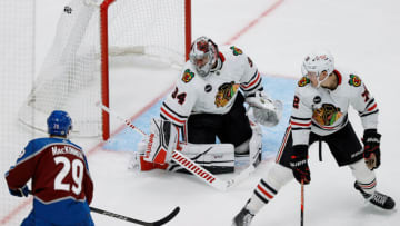 Oct 19, 2023; Denver, Colorado, USA; Colorado Avalanche center Nathan MacKinnon (29) scores a goal against Chicago Blackhawks goaltender Petr Mrazek (34) as left wing Lukas Reichel (27) defends in the third period at Ball Arena. Mandatory Credit: Isaiah J. Downing-USA TODAY Sports