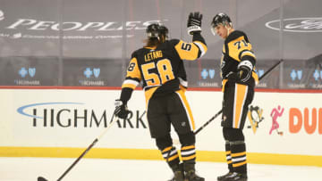 Jan 19, 2021; Pittsburgh, Pennsylvania, USA; Pittsburgh Penguins center Evgeni Malkin (71) is congratulated by defenseman Kris Letang (58) after scoring a goal in the second period against the Washington Capitals at PPG Paints Arena. Mandatory Credit: Philip G. Pavely-USA TODAY Sports