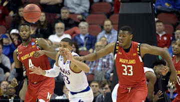 Mar 24, 2016; Louisville, KY, USA; Kansas Jayhawks forward Landen Lucas (33) and Maryland Terrapins center Diamond Stone (33) go for a loose ball during the second half in a semifinal game in the South regional of the NCAA Tournament at KFC YUM!. Mandatory Credit: Jamie Rhodes-USA TODAY Sports