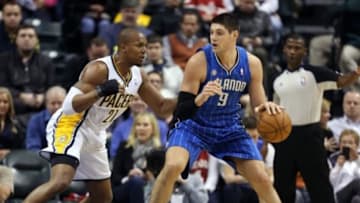 Feb 3, 2014; Indianapolis, IN, USA; Orlando Magic center Nikola Vucevic (9) is guarded by Indiana Pacers forward David West (21) at Bankers Life Fieldhouse. Indiana defeats Orlando 98-79. Mandatory Credit: Brian Spurlock-USA TODAY Sports