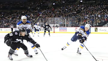 Dec 4, 2015; Brooklyn, NY, USA; St. Louis Blues defenseman Jay Bouwmeester (19) reaches for the puck as as New York Islanders center Ryan Strome (18) defends during the second period at Barclays Center. Mandatory Credit: Anthony Gruppuso-USA TODAY Sports