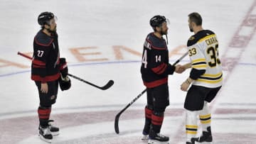 RALEIGH, NORTH CAROLINA - MAY 16: Zdeno Chara #33 of the Boston Bruins shakes hands with Justin Williams #14 of the Carolina Hurricanes after defeating the Carolina Hurricanes in Game Four to win the Eastern Conference Finals during the 2019 NHL Stanley Cup Playoffs at PNC Arena on May 16, 2019 in Raleigh, North Carolina. (Photo by Grant Halverson/Getty Images)