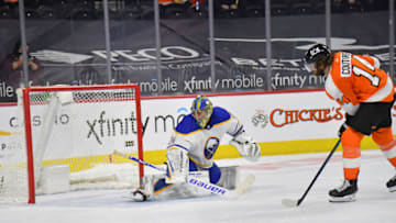 Mar 9, 2021; Philadelphia, Pennsylvania, USA; Philadelphia Flyers center Sean Couturier (14) scores a goal past Buffalo Sabres goaltender Jonas Johansson (34) during a shootout at Wells Fargo Center. Mandatory Credit: Eric Hartline-USA TODAY Sports
