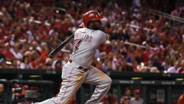 Sep 26, 2016; St. Louis, MO, USA; Cincinnati Reds second baseman Brandon Phillips (4) hits a two-run single off of St. Louis Cardinals relief pitcher Michael Wacha (not pictured) during the fourth inning at Busch Stadium. Mandatory Credit: Jeff Curry-USA TODAY Sports