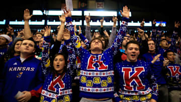 Kansas basketball fans wearing ugly Christmas Sweaters cheer. (Photo by Jamie Squire/Getty Images)
