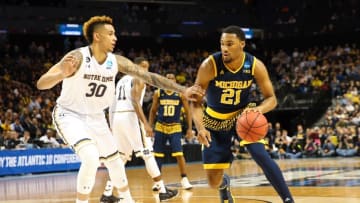 Mar 18, 2016; Brooklyn, NY, USA; Michigan Wolverines guard Zak Irvin (21) dribbles against Notre Dame Fighting Irish forward Zach Auguste (30) in the first half in the first round of the 2016 NCAA Tournament at Barclays Center. Mandatory Credit: Anthony Gruppuso-USA TODAY Sports