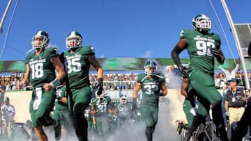 Oct 25, 2014; East Lansing, MI, USA; Michigan State Spartans quarterback Connor Cook (18) and defensive end Evan Jones (85) and defensive lineman Joel Heath (92) takes the field prior to a game at Spartan Stadium. Mandatory Credit: Mike Carter-USA TODAY Sports