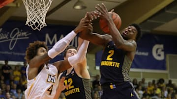 HONOLULU, HI - NOVEMBER 11: Sacar Anim #2 and Matt Heldt #12 of the Marquette Golden Eagles battle with Justin Tillman #4 of the VCU Rams for a rebound during the first half of their game at Aloha Stadium on November 11, 2017 in Honolulu, Hawaii. (Photo by Darryl Oumi/Getty Images)