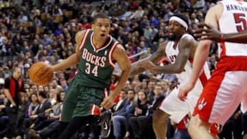 Apr 14, 2014; Toronto, Ontario, CAN; Milwaukee Bucks guard-forward Giannis Antetokounmpo (34) drives to the net against Toronto Raptors guard-forward John Salmons (25) at the Air Canada Centre. Toronto defeated Milwaukee 110-100. Mandatory Credit: John E. Sokolowski-USA TODAY Sports