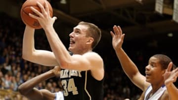 Feb 4, 2014; Durham, NC, USA; Wake Forest Demon Deacons forward Tyler Cavanaugh (34) drives past Duke Blue Devils forward Amile Jefferson (21) and guard Andre Dawkins (34) at Cameron Indoor Stadium. Mandatory Credit: Mark Dolejs-USA TODAY Sports