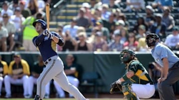 Feb 27, 2014; Phoenix, AZ, USA; Milwaukee Brewers left fielder Ryan Braun (8) hits a home run against the Oakland Athletics during the first inning at Phoenix Municipal Stadium. Mandatory Credit: Joe Camporeale-USA TODAY Sports