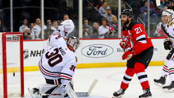 NEWARK, NJ - JANUARY 14: New Jersey Devils right wing Kyle Palmieri (21) shoots and scores past Chicago Blackhawks goaltender Cam Ward (30) during the second period of the National Hockey League game between the New Jersey Devils and the Chicago Blackhawks on January 14, 2019, at the Prudential Center in Newark, NJ. (Photo by Rich Graessle/Icon Sportswire via Getty Images)