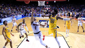 DES MOINES, IOWA - MARCH 21: Christen Cunningham #1 of the Louisville Cardinals takes a shot against Daniel Oturu #25 of the Minnesota Golden Gophers during their game in the First Round of the NCAA Basketball Tournament at Wells Fargo Arena on March 21, 2019 in Des Moines, Iowa. (Photo by Andy Lyons/Getty Images)