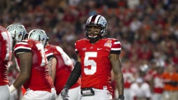 Jan 3, 2014; Miami Gardens, FL, USA; Ohio State Buckeyes quarterback Braxton Miller (5) looks to the sidelines during the first half in the 2014 Orange Bowl college football game against the Clemson Tigers at Sun Life Stadium. Mandatory Credit: Joshua S. Kelly-USA TODAY Sports