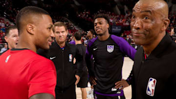 PORTLAND, OR - OCTOBER 12: Referee Official Mark Ayotte leads a huddle between Damian Lillard #0 of the Portland Trail Blazers and Buddy Hield #24 of the Sacramento Kings as they greet each other before the game on October 12, 2018 at the Moda Center Arena in Portland, Oregon. NOTE TO USER: User expressly acknowledges and agrees that, by downloading and or using this photograph, user is consenting to the terms and conditions of the Getty Images License Agreement. Mandatory Copyright Notice: Copyright 2018 NBAE (Photo by Cameron Browne/NBAE via Getty Images)
