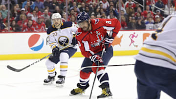 WASHINGTON, DC - DECEMBER 15: Alex Ovechkin #8 of the Washington Capitals skates past Sam Reinhart #23 of the Buffalo Sabres during the second period at Capital One Arena on December 15, 2018 in Washington, DC. (Photo by Patrick Smith/Getty Images)