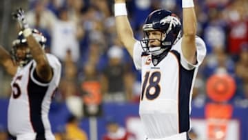 Sep 15, 2013; East Rutherford, NJ, USA; Denver Broncos quarterback Peyton Manning (18) celebrates a touchdown against the New York Giants during the game at MetLife Stadium. Mandatory Credit: Chris Faytok/THE STAR-LEDGER via USA TODAY Sports