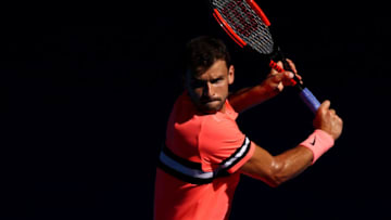 MELBOURNE, AUSTRALIA - JANUARY 23: Grigor Dimitrov of Bulgaria plays a backhand in his quarter-final match against Kyle Edmund of Great Britain on day nine of the 2018 Australian Open at Melbourne Park on January 23, 2018 in Melbourne, Australia. (Photo by Cameron Spencer/Getty Images)
