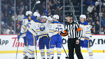Jan 26, 2023; Winnipeg, Manitoba, CAN; Buffalo Sabres forward Owen Power (25) is congratulated by his team mates on his goal against the Winnipeg Jets during the second period at Canada Life Centre. Mandatory Credit: Terrence Lee-USA TODAY Sports