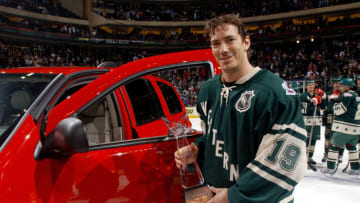 ST. PAUL, MN - FEBRUARY 8: Western Conference All Star Joe Sakic #19 of the Colorado Avalanche poses with his MVP award and his new car after playing in the 54th NHL All-Star Game on February 8, 2004 at the Xcel Energy Center in St. Paul, Minnesota. The East defeated the West 6-4. (Photo by Dave Sandford/Getty Images)