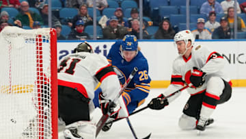 BUFFALO, NY - FEBRUARY 17: Anton Forsberg #31 of the Ottawa Senators makes the save against Rasmus Dahlin #26 of the Buffalo Sabres as Josh Brown #3 defends during the third period at KeyBank Center on February 17, 2022 in Buffalo, New York. (Photo by Kevin Hoffman/Getty Images)