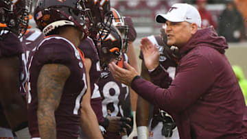 BLACKSBURG, VA - NOVEMBER 23: Head coach Justin Fuente of the Virginia Tech Hokies huddles with his team prior to the game against the Pittsburgh Panthers at Lane Stadium on November 23, 2019 in Blacksburg, Virginia. (Photo by Michael Shroyer/Getty Images)