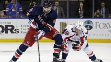 Jan 9, 2016; New York, NY, USA; New York Rangers left wing Rick Nash (61) battles for the puck with Washington Capitals defenseman Nate Schmidt (88) during overtime of an NHL hockey game at Madison Square Garden. The Capitals defeated the Rangers 4-3 in overtime. Mandatory Credit: Adam Hunger-USA TODAY Sports