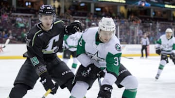 CLEVELAND, OH - MARCH 17: Texas Stars C Jason Dickinson (38) plays the puck along the boards as Cleveland Monsters C Sam Vigneault (19) defends during the second period of the AHL hockey game between the Texas Stars and Cleveland Monsters on March 17, 2017, at Quicken Loans Arena in Cleveland, OH. Texas defeated Cleveland 4-0. (Photo by Frank Jansky/Icon Sportswire via Getty Images)