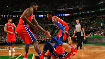 BOSTON, MA - APRIL 28: Ben Simmons #25 of the Philadelphia 76ers is assisted off the floor by teammates Robert Covington #33 and Amir Johnson #5 in Game One of the Eastern Conference Semifinals of the 2018 NBA Playoffs against the Boston Celtics on April 30, 2018 at the TD Garden in Boston, Massachusetts. NOTE TO USER: User expressly acknowledges and agrees that, by downloading and or using this photograph, User is consenting to the terms and conditions of the Getty Images License Agreement. Mandatory Copyright Notice: Copyright 2018 NBAE (Photo by Jesse D. Garrabrant/NBAE via Getty Images)