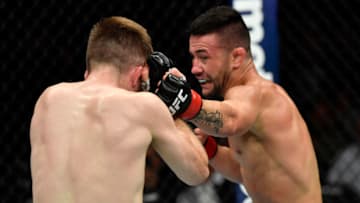 LOS ANGELES, CA - AUGUST 04: (R-L) Pedro Munhoz of Brazil punches Brett Johns of Wales in their bantamweight fight during the UFC 227 event inside Staples Center on August 4, 2018 in Los Angeles, California. (Photo by Jeff Bottari/Zuffa LLC/Zuffa LLC via Getty Images)