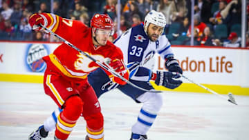 Dec 10, 2016; Calgary, Alberta, CAN; Calgary Flames center Lance Bouma (17) and Winnipeg Jets defenseman Dustin Byfuglien (33) during the third period at Scotiabank Saddledome. Calgary Flames won 6-2. Mandatory Credit: Sergei Belski-USA TODAY Sports