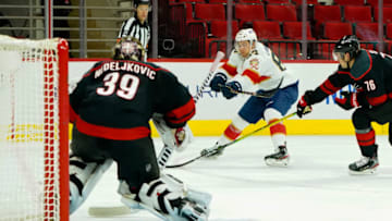 Feb 17, 2021; Raleigh, North Carolina, USA; Florida Panthers right wing Juho Lammikko (83) scores a third period goal against Carolina Hurricanes goaltender Alex Nedeljkovic (39) at PNC Arena. Mandatory Credit: James Guillory-USA TODAY Sports