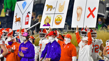 Nov 7, 2020; South Bend, Indiana, USA; Clemson Tigers sideline personnel hold play signal cards in the third quarter against the Notre Dame Fighting Irish at Notre Dame Stadium. Notre Dame defeated Clemson 47-40 in two overtimes. Mandatory Credit: Matt Cashore-USA TODAY Sports