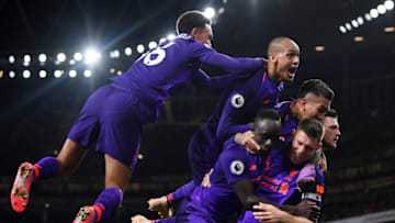 LONDON, ENGLAND - NOVEMBER 03: James Milner of Liverpool celebrates with Sadio Mane, Andy Robertson, Roberto Firmino and Fabinho of Liverpool after he scores his sides first goal during the Premier League match between Arsenal FC and Liverpool FC at Emirates Stadium on November 3, 2018 in London, United Kingdom. (Photo by Michael Regan/Getty Images)