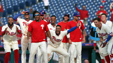 PHILADELPHIA, PA - JULY 1: The Philadelphia Phillies surround home plate to celebrate with Andrew Knapp #15 (not pictured) after he hit a game winning, walk off, solo home run in the 13th inning during a game against the Washington Nationals at Citizens Bank Park on July 1, 2018 in Philadelphia, Pennsylvania. The Phillies won 4-3 in 13 innings. (Photo by Hunter Martin/Getty Images)
