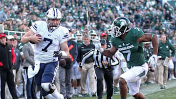 Oct 8, 2016; East Lansing, MI, USA; Brigham Young Cougars quarterback Taysom Hill (7) is run out of bounds by Michigan State Spartans defensive back Demetrious Cox (7) during the second half of a game at Spartan Stadium. Mandatory Credit: Mike Carter-USA TODAY Sports