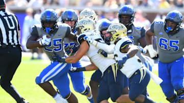 ATLANTA, GA - OCTOBER 13: Deon Jackson #25 of the Duke Blue Devils breaks the tackle of Brant Mitchell #51 of the Georgia Tech Yellow Jackets on October 13, 2018 in Atlanta, Georgia. (Photo by Scott Cunningham/Getty Images)