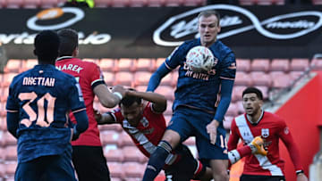 vies with Arsenal's Scottish defender Kieran Tierney Arsenal's English defender Rob Holding during the English FA Cup fourth round football match between Southampton and Arsenal at St Mary's Stadium in Southampton, Hampshire,on January 23, 2021. (Photo by Ben STANSALL / AFP) / RESTRICTED TO EDITORIAL USE. No use with unauthorized audio, video, data, fixture lists, club/league logos or 'live' services. Online in-match use limited to 120 images. An additional 40 images may be used in extra time. No video emulation. Social media in-match use limited to 120 images. An additional 40 images may be used in extra time. No use in betting publications, games or single club/league/player publications. / (Photo by BEN STANSALL/AFP via Getty Images)