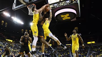 Dec 6, 2016; Ann Arbor, MI, USA; Texas Longhorns guard Kerwin Roach Jr. (12) in the second half forward Moritz Wagner (13) and Michigan Wolverines forward D.J. Wilson (5) blocks a shot bat Crisler Center. Michigan won 53-50. Mandatory Credit: Rick Osentoski-USA TODAY Sports