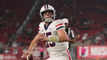 LOS ANGELES, CALIFORNIA - OCTOBER 30: Quarterback Will Plummer #15 of the Arizona Wildcats scrambles with the ball against the USC Trojans during a college football game between the Arizona Wildcats and the USC Trojans at Los Angeles Memorial Coliseum on October 30, 2021 in Los Angeles, California. (Photo by Leon Bennett/Getty Images)