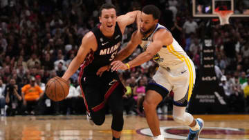 Miami Heat guard Duncan Robinson (55) drives the ball around Golden State Warriors guard Stephen Curry (30)(Jasen Vinlove-USA TODAY Sports)