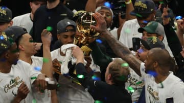 MILWAUKEE, WISCONSIN - JULY 20: Khris Middleton #22 of the Milwaukee Bucks receives the championship trophy from head coach Mike Budenholzer after defeating the Phoenix Suns in Game Six to win the 2021 NBA Finals at Fiserv Forum on July 20, 2021 in Milwaukee, Wisconsin. NOTE TO USER: User expressly acknowledges and agrees that, by downloading and or using this photograph, User is consenting to the terms and conditions of the Getty Images License Agreement. (Photo by Jonathan Daniel/Getty Images)