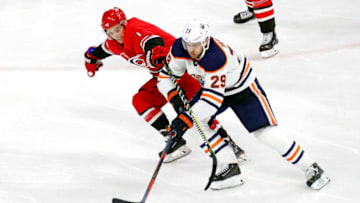 The Carolina Hurricanes' Derek Ryan (7) pressures the Edmonton Oilers' Leon Draisaitl (29) during the third period at PNC Arena in Raleigh, N.C., on Tuesday, March 20, 2018. The Oilers won, 7-3. (Chris Seward/Raleigh News