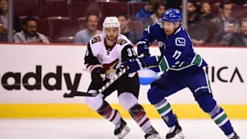 Oct 3, 2016; Vancouver, British Columbia, CAN; Vancouver Canucks forward Anton Rodin (17) and Arizona Coyotes defenseman Alex Goligoski (33) battle for the puck during a preseason hockey game at Rogers Arena. Mandatory Credit: Anne-Marie Sorvin-USA TODAY Sports