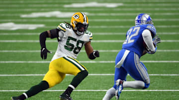 DETROIT, MICHIGAN - DECEMBER 13: Christian Kirksey #58 of the Green Bay Packers chases D'Andre Swift #32 of the Detroit Lions during the second half at Ford Field on December 13, 2020 in Detroit, Michigan. (Photo by Nic Antaya/Getty Images)