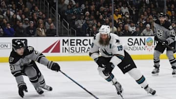 Dec 31, 2016; Los Angeles, CA, USA; San Jose Sharks center Joe Thornton (19) handles the puck as Los Angeles Kings center Nick Shore (21) defends in the third period during a NHL hockey match at Staples Center. The Kings defeated the Sharks 3-2. Mandatory Credit: Kirby Lee-USA TODAY Sports
