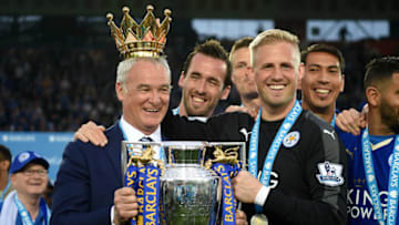 LEICESTER, ENGLAND - MAY 07: Claudio Ranieri poses with the Premier League Trophy while Kasper Schmeichel puts the crown on the head of the manager as players and staffs celebrate the season champions after the Barclays Premier League match between Leicester City and Everton at The King Power Stadium on May 7, 2016 in Leicester, United Kingdom. (Photo by Michael Regan/Getty Images)