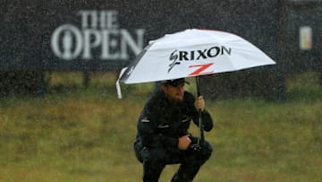 PORTRUSH, NORTHERN IRELAND - JULY 21: Shane Lowry of Ireland shelters from the rain as he lines up a putt on the eighth green during the final round of the 148th Open Championship held on the Dunluce Links at Royal Portrush Golf Club on July 21, 2019 in Portrush, United Kingdom. (Photo by Mike Ehrmann/Getty Images)