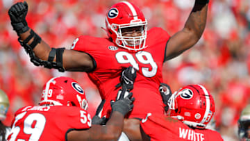ATHENS, GA - NOVEMBER 20: Jordan Davis #99 of the Georgia Bulldogs reacts after rushing in for a touchdown during the first half against the Charleston Southern Buccaneers at Sanford Stadium on November 20, 2021 in Athens, Georgia. (Photo by Todd Kirkland/Getty Images)